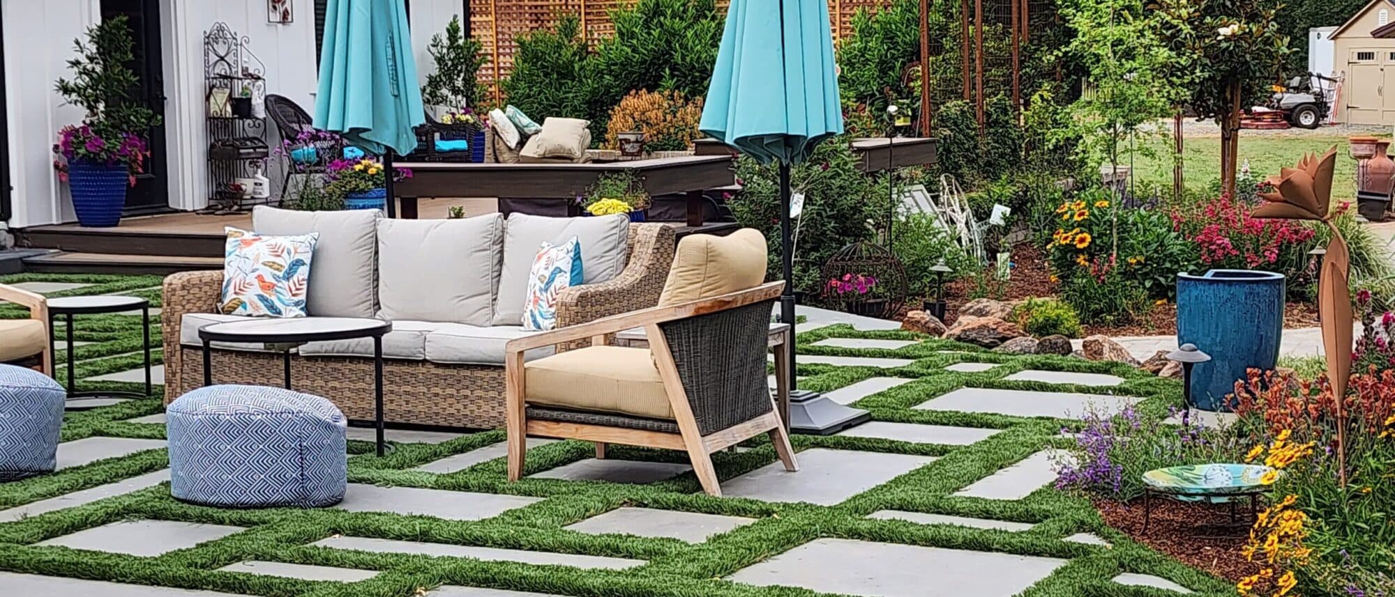 Paver patio set with artificial turf joints and cushioned outdoor lounge seating